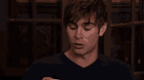 a man is holding a cup of coffee in his hand .