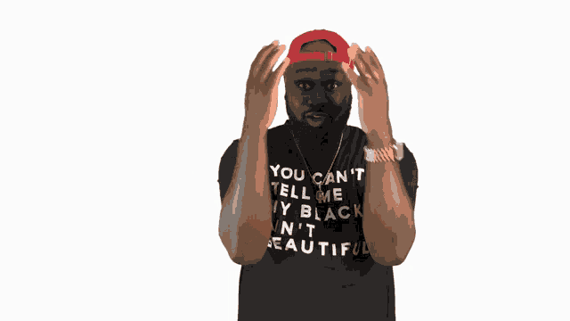 a man wearing a black shirt that says you can 't tell me i 'm black n ' t beautiful