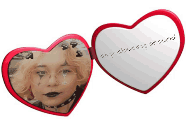 a heart shaped mirror with a picture of a woman and arabic writing on it