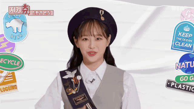 a girl in a beret with a sticker that says recycle on it