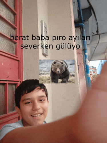 a boy with a picture of a bear and the words berat baba piro aylari severken guluyo behind him