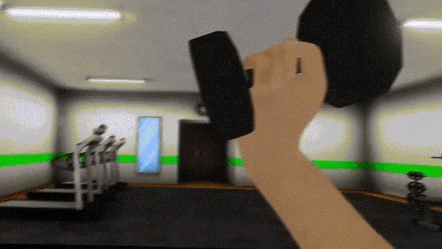 a person is holding a black object in a gym