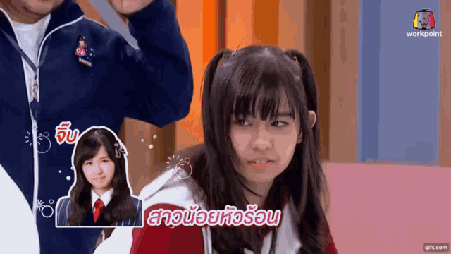 a girl with pigtails is making a funny face in a video .