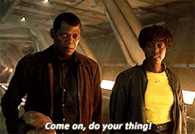 a man and a woman are standing next to each other with the man saying come on do your thing