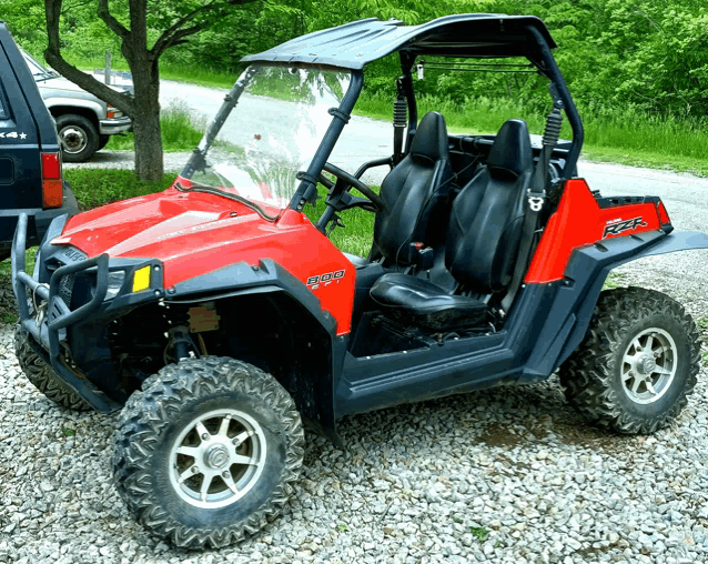 a red and black atv with the word rzr on the side