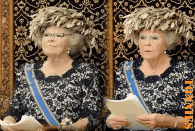 two women wearing feathered hats are standing next to each other in front of a wall with the word toatjes on the bottom