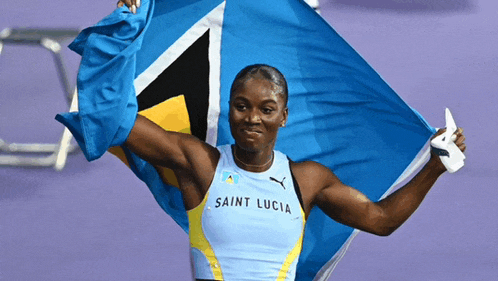 a woman in a saint lucia tank top holds a flag