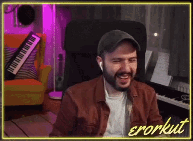 a man is sitting in a chair with a keyboard in front of him and the word errorkut is on the bottom right