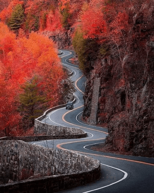 a car is driving down a very curvy road