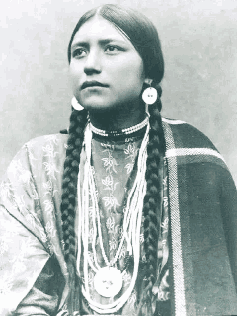 a black and white photo of a native american woman with braids