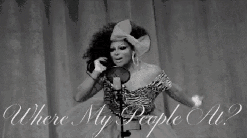 a drag queen is singing into a microphone with the words where my people all written below her