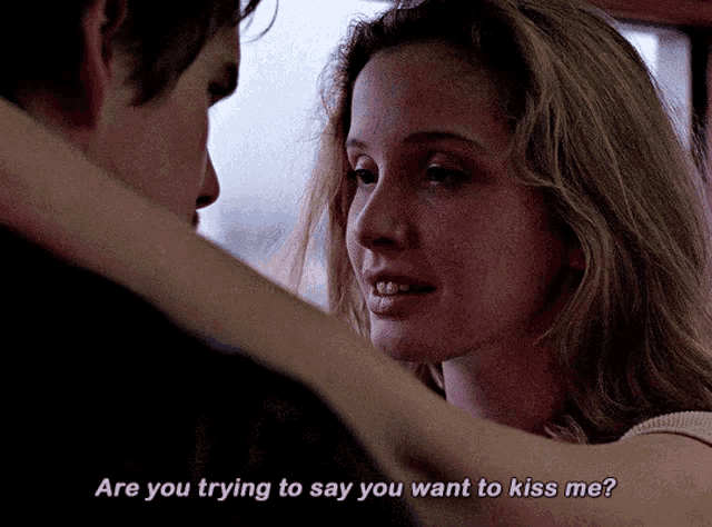 a man and a woman are looking at each other with the words are you trying to say you want to kiss me