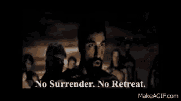 a man with a beard is standing in front of a group of people and saying no surrender no retreat .