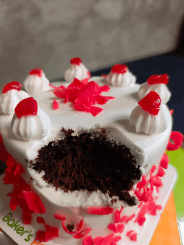 a cake with a slice taken out of it that says bakers on it