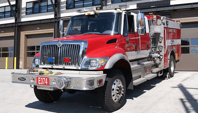 a red fire truck with a license plate e374