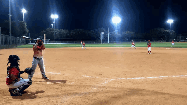 a baseball game is being played at night and the batter is wearing a jersey that says ' a' on it