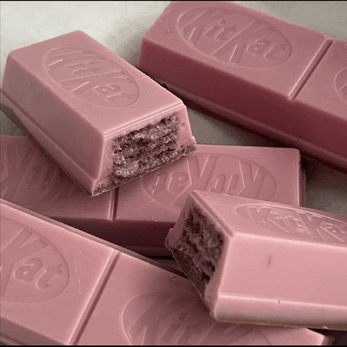 a pink kitkat bar with a bite out of it