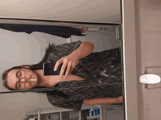 a man taking a picture of himself in a bathroom mirror