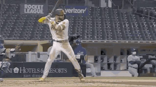 a baseball player wearing a white jersey with the word padres on it is standing on a baseball field .