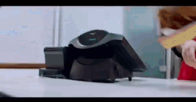 a person is cutting a piece of cheese with a slicer