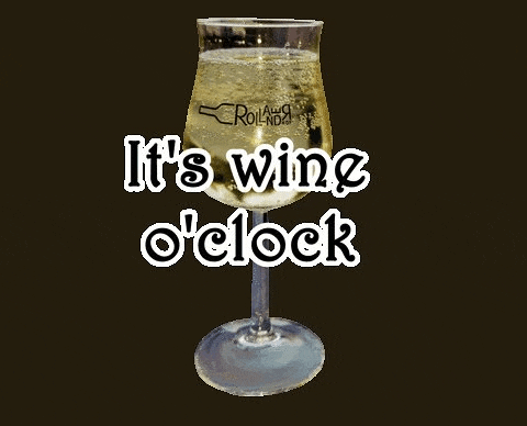 a wine glass with the words `` it 's wine o 'clock '' written on it .