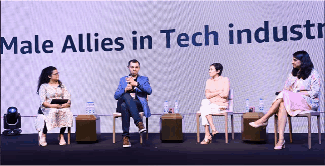 a group of people sitting in front of a screen that says " male allies in tech industry "