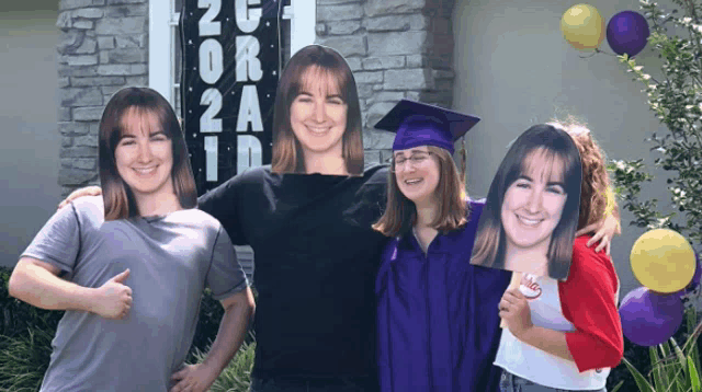 a group of people standing in front of a sign that says graduation 2021