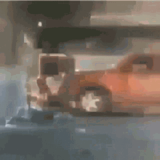 a blurry picture of a white truck and an orange car