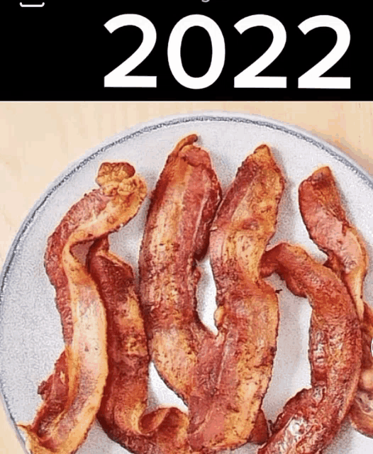 a plate of bacon with the year 2022 written on it