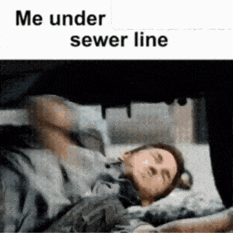 a man laying under a sewer line with a caption that reads me under sewer line
