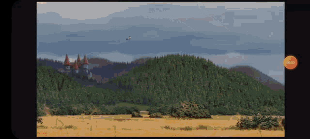 a screen shows a castle on top of a hill in the distance with a pause button in the upper right corner