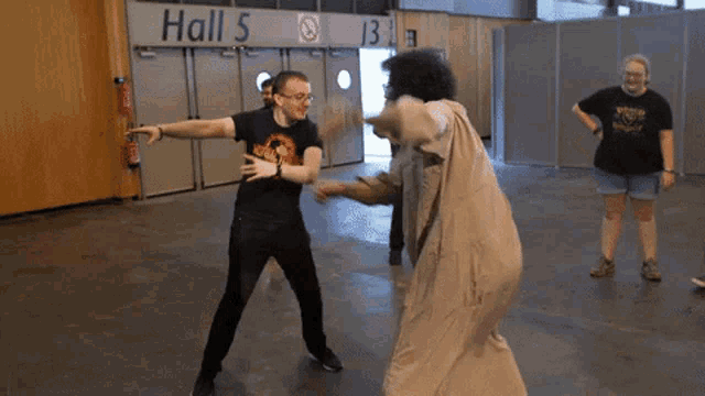 a man standing in front of a sign that says hall 5 on it