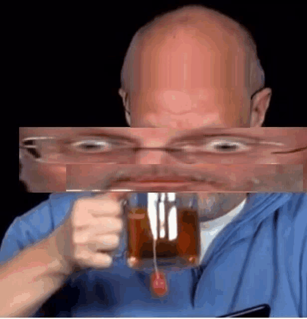 a bald man is drinking a cup of tea with a cherry on it .