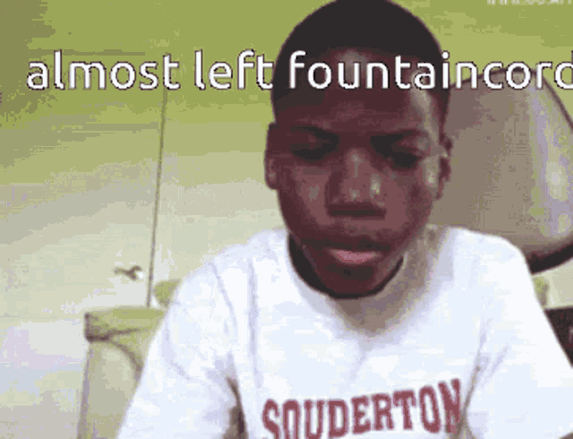 a boy wearing a shirt that says souderton on the front