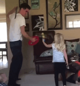 a man and a girl are playing a game in a living room