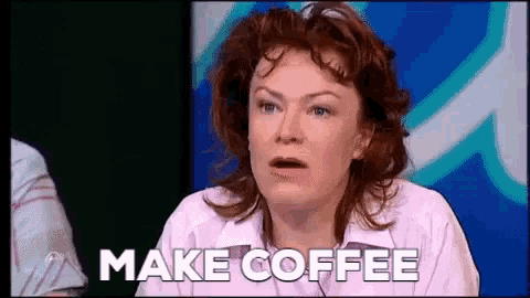 a woman is sitting at a table and saying make coffee