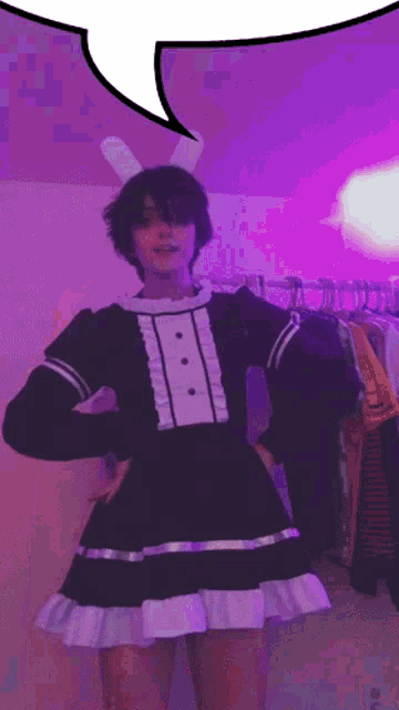 a person wearing bunny ears and a maid dress with a speech bubble above them