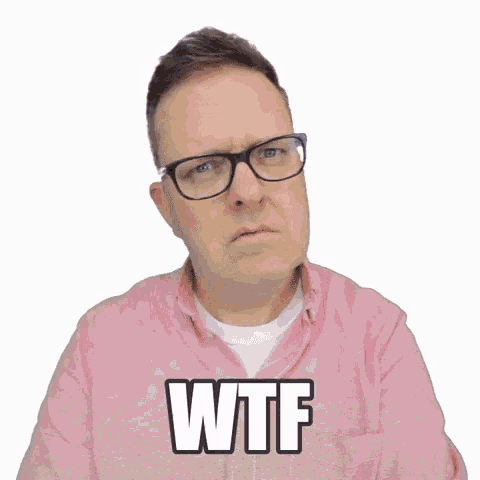 a man wearing glasses and a pink shirt is making a funny face and says wtf .