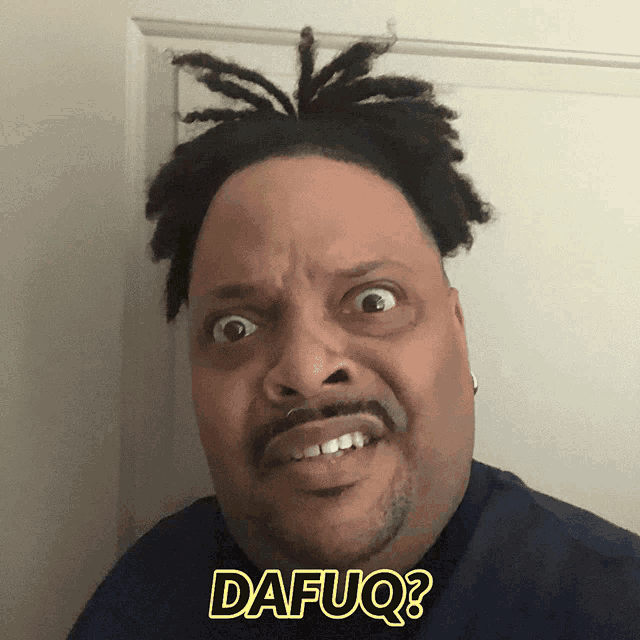 a man with dreadlocks is making a funny face and has the word dafuq on his shirt