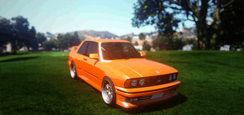 an orange car is parked on a grassy field