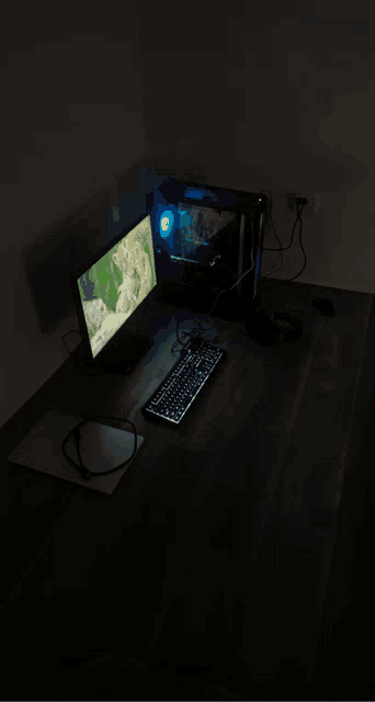 a dark room with a computer and keyboard