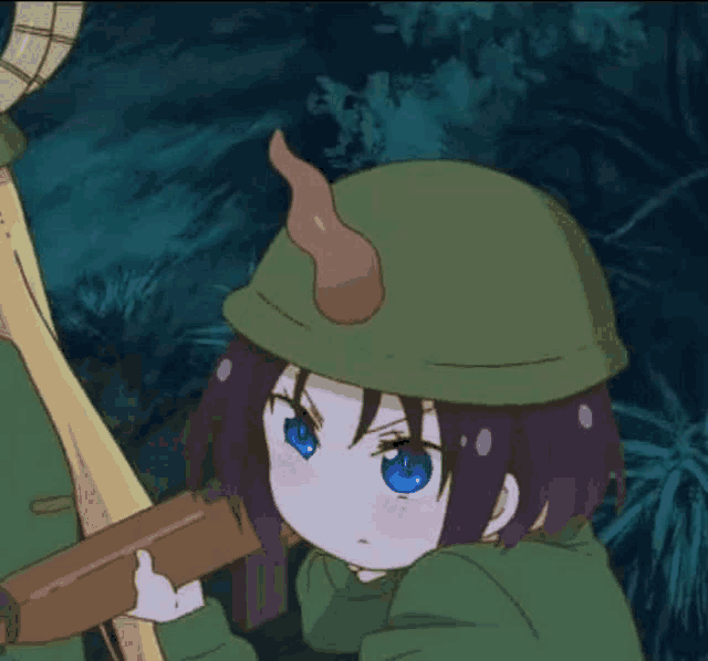 a little girl with blue eyes is wearing a green hat and holding a sword .