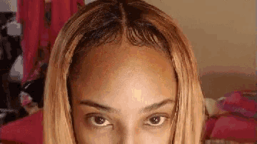 a close up of a woman 's forehead with blonde hair .