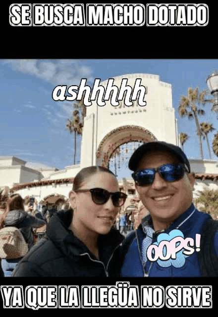 a man and a woman are posing for a picture in front of a building that says se busca macho dotado