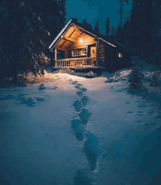 footprints in the snow lead to a log cabin