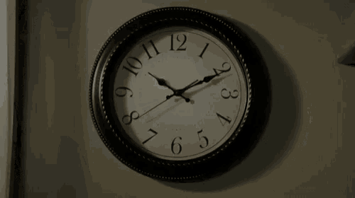 a black and white clock with the hands on the numbers 1 and 12