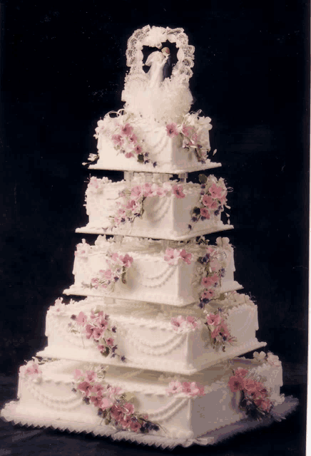 a wedding cake with a bride and groom on top