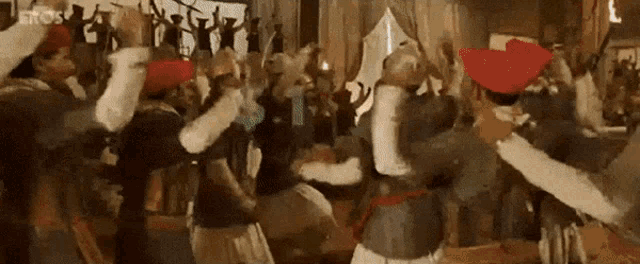 a group of people are dancing in a room in a room .