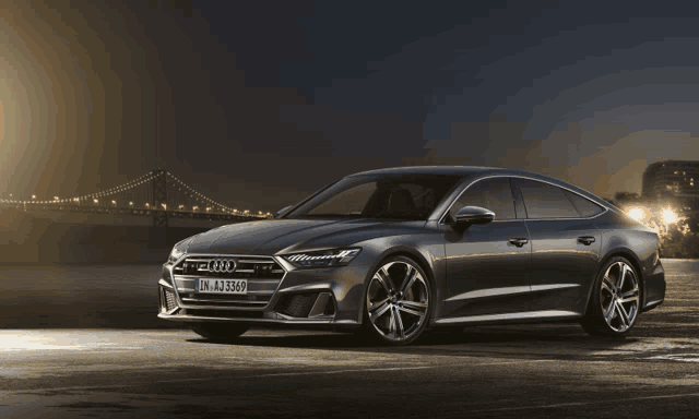 an audi a7 is parked in a parking lot at night