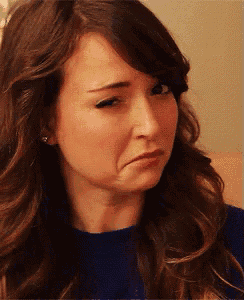 a close up of a woman 's face with a sad look on her face